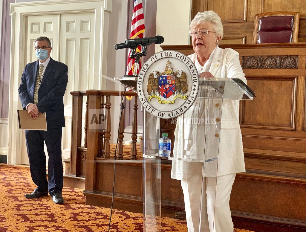 Alabama Gov. Kay Ivey, right, and State Health Officer Scott Harris announce the extension of a state order requiring face masks in public during a press conference, Wednesday, July 29, 2020, in Montgomery, Alabama. Ivey extended a state order requiring face coverings in public for another month and expanded it to include students in grade 2 and above in an attempt to slow the spread of COVID-19 as schools reopen. (AP Photo/Kim Chandler)