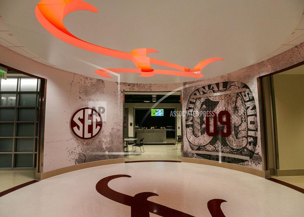 FILE - In this Aug. 1, 2013, file photo, a lit up script A is a feature of a walkway during a tour of the football locker-room facility at the Mal M. Moore Athletic Facility at the University of Alabama in Tuscaloosa, Ala. Four Mississippi State University students are accused of breaking into the University of Alabama's athletic facility and stealing memorabilia. The break-in happened during the pre-dawn hours of April 4, 2018, six days before Alabama's national championship football team met with President Donald Trump at the White House, authorities said. The four managed to get inside the Mal M. Moore Athletic Facility and stole "various items of memorabilia," court records state. (Vasha Hunt/AL.com via AP)