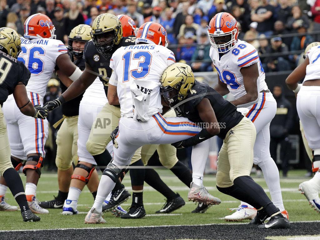 Mark Humphrey CORRECTS TO STOPPED SHORT OF THE GOAL LINE, NOT A TOUCHDOWN - Florida quarterback Feleipe Franks (13) is stopped short of the goal line by Vanderbilt defensive back Randall Haynie (4) in the first half of an NCAA college football game Saturday, Oct. 13, 2018, in Nashville, Tenn. (AP Photo/Mark Humphrey)