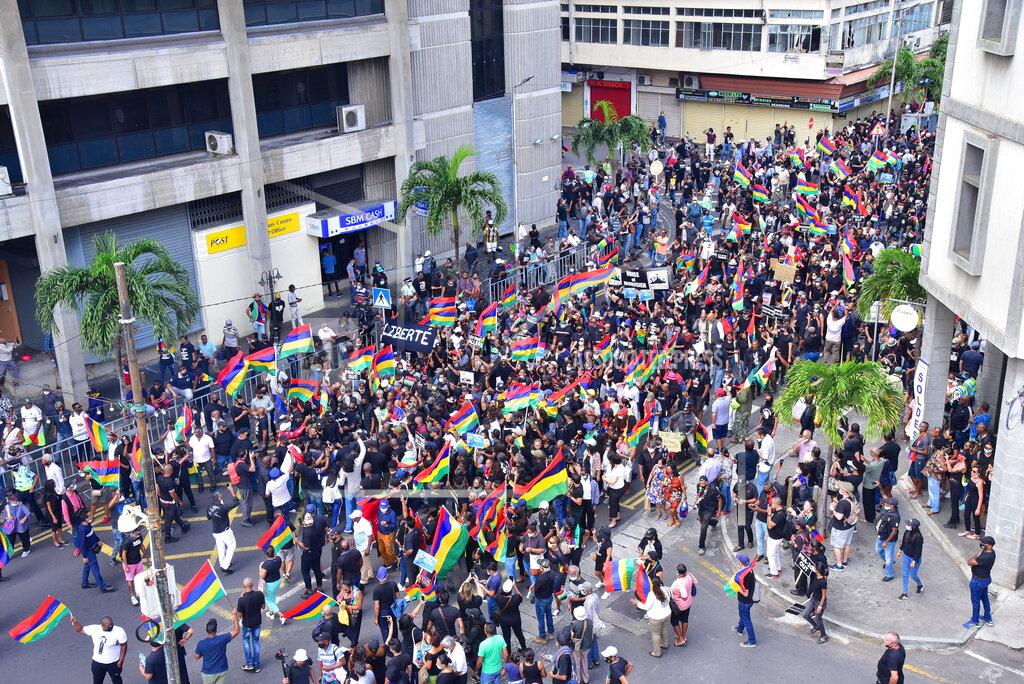 Beekash Roopun Tens of thousands of people protest in Port Louis, Mauritius, Saturday Aug. 29, 2020, over the government's slow response to an oil spill from a grounded Japanese ship and the alarming discovery of dozens of dead dolphins. (Beekash Roopun/L'express Maurice via AP)