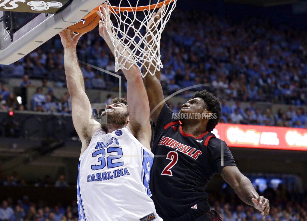 Gerry Broome North Carolina's Luke Maye (32) shoots while Louisville's Darius Perry (2) defends during the first half of an NCAA college basketball game in Chapel Hill, N.C., Saturday, Jan. 12, 2019. (AP Photo/Gerry Broome)