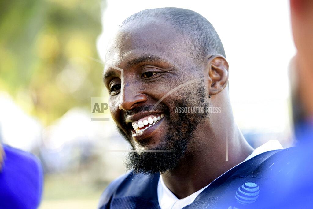 FILE - In this July 29, 2019, file photo, Dallas Cowboys defensive end Robert Quinn talks with reporters at the NFL football team's training camp in Oxnard, Calif. Robert Quinn is set for his Dallas debut against Miami after the Dolphins traded the defensive end to the Cowboys in the offseason. Quinn served a two-game suspension over performance enhancers. (AP Photo/Michael Owen Baker, File)