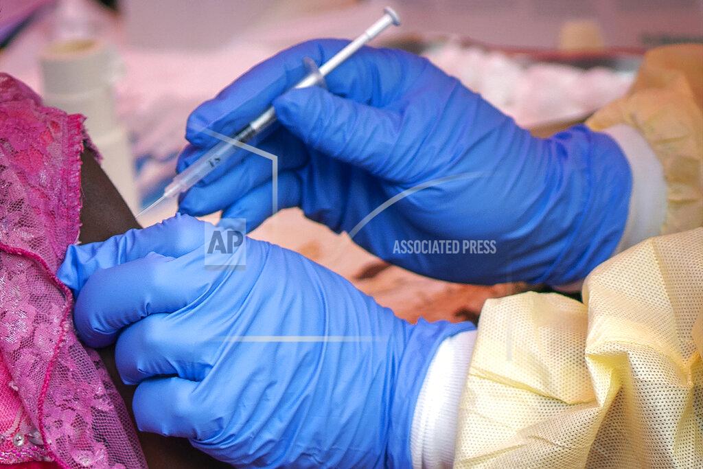 Jerome Delay FILE - In this Saturday, July 13, 2019 file photo, a person is vaccinated against Ebola in Beni, Congo. According to a report published in the New England Journal of Medicine on Wednesday, March 31, 2021, an African man who developed Ebola despite receiving a vaccine recovered, but he suffered a relapse nearly six months later that led to 91 new cases before he died. The report adds to evidence that the deadly virus can lurk in the body long after symptoms end, and that survivors need monitoring for their own welfare and to prevent spread. (AP Photo/Jerome Delay, File)