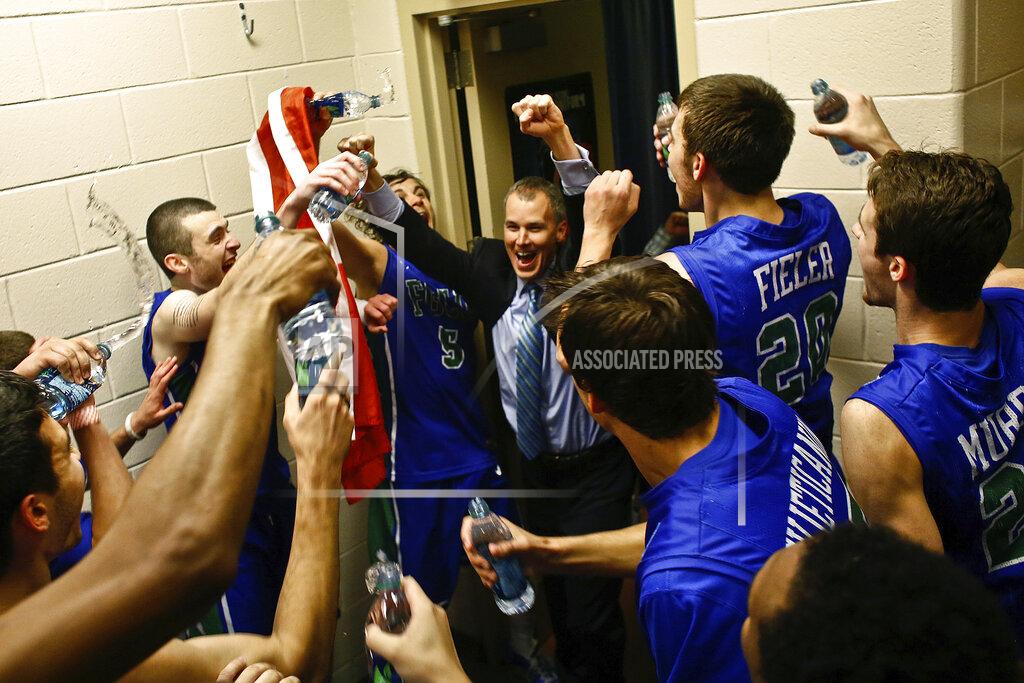 Scott Mcintyre FILE - In this March 24, 2013, file photo, Florida Gulf Coast players celebrate with coach Andy Enfield in the team's locker room after winning a third-round game against San Diego State in the NCAA college basketball tournament in Philadelphia. No team seeded so low has gone so far. They remain the biggest party crashers in tournament history, not just because of their seeding but also because they were in only their second season of full Division I eligibility. (Scott McIntyre/Naples Daily News via AP, File)