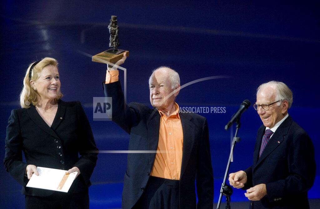 Lien FILE - British theatre director Peter Brook, centre, receives the 2008 Ibsen Award from the committee chairman, actress Liv Ullmann, left, and Henrik Ibsens, at a ceremony in the National Theatre, Oslo, Sunday, Aug. 31, 2008. Brook, a British theater director known for an influential and distinguished career which saw him garner worldwide acclaim, has died. He was 97. The two-time Tony Award winner, who had settled in France since the 1970s, also directed the film adaptations of his best stage works as well as the 1963 release of “Lord of the Flies”. (Kyrre Lien, NTB Scanpix via AP, FIle)
