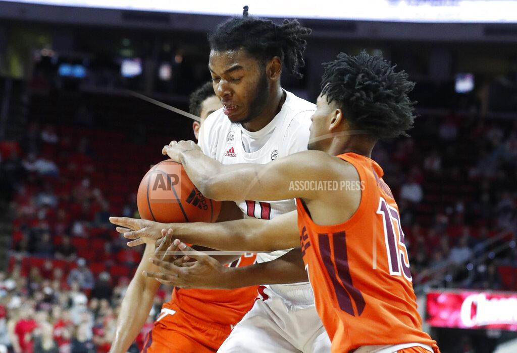 Ethan Hyman North Carolina State's Jaylon Gibson (11) can't hold onto the ball as Virginia Tech's Darius Maddox (13) steals it during the first half of an NCAA college basketball game in Raleigh, N.C., Wednesday, Jan. 19, 2022. (Ethan Hyman/The News & Observer via AP)