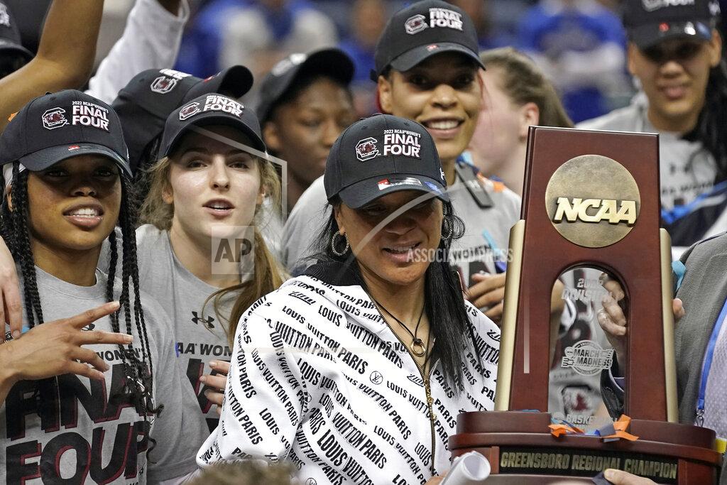 Gerry Broome South Carolina head coach Dawn Staley is seen with the trophy following a college basketball game against Creighton in the Elite 8 round of the NCAA tournament in Greensboro, N.C., Sunday, March 27, 2022. (AP Photo/Gerry Broome)