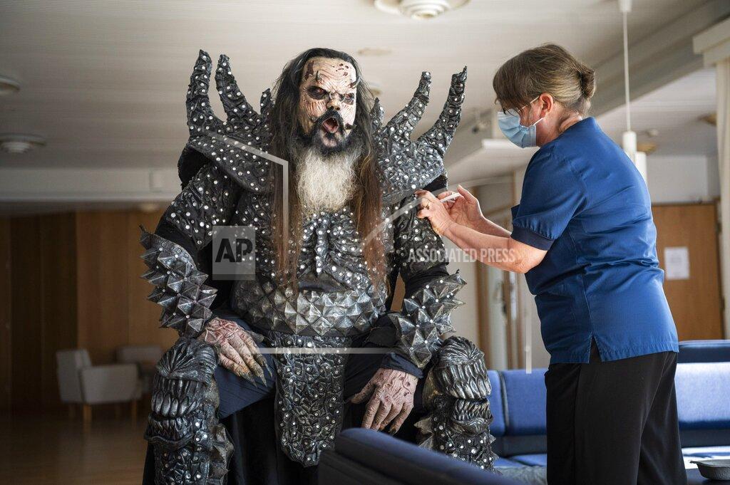 Jouni Porsanger Mr Lordi of the Finnish hard rock band Lordi receives his second Covid-19 vaccination from nurse Paula Ylitalo in Rovaniemi, Finland, Sunday, Aug. 1, 2021. (Jouni Porsanger/Lehtikuva via AP)