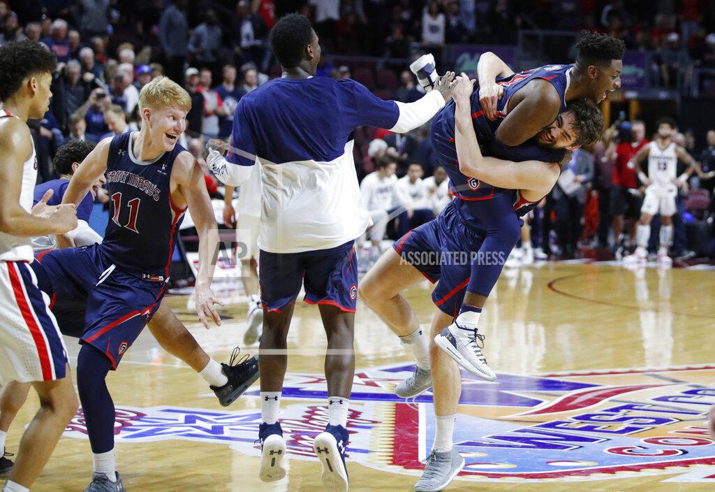 John Locher St. Mary's Jordan Hunter, right, and Malik Fitts, second from right, celebrate after their team defeated Gonzaga 60-47 in an NCAA college basketball game for the West Coast Conference men's tournament title, Tuesday, March 12, 2019, in Las Vegas. (AP Photo/John Locher)