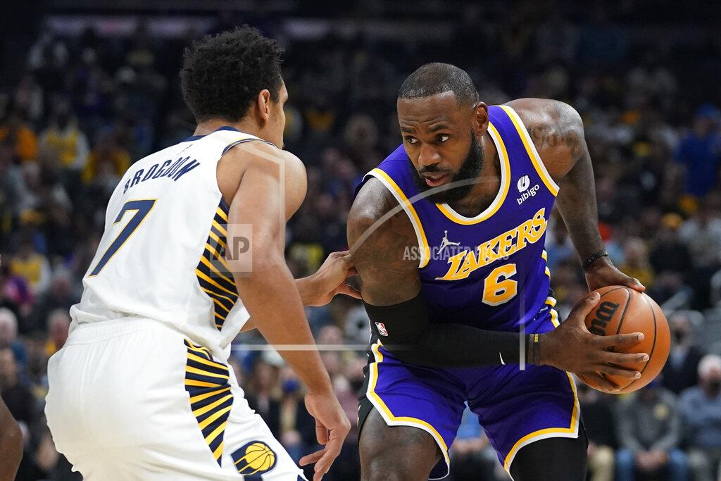 Darron Cummings Los Angeles Lakers' LeBron James (6) is defended by Indiana Pacers' Malcolm Brogdon (7 during the first half of an NBA basketball game Wednesday, Nov. 24, 2021, in Indianapolis. (AP Photo/Darron Cummings)