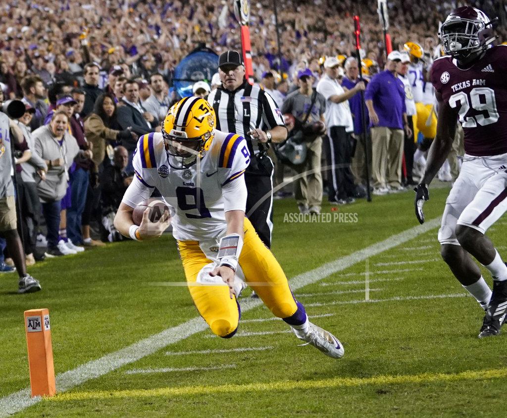David J. Phillip LSU quarterback Joe Burrow (9) dives to score a touchdown as Texas A&M defensive back Debione Renfro (29) defends during the first half of an NCAA college football game Saturday, Nov. 24, 2018, in College Station, Texas. (AP Photo/David J. Phillip)