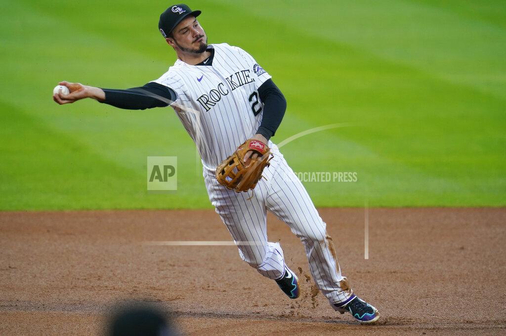 David Zalubowski Colorado Rockies third baseman Nolan Arenado throws late to first base after fielding an infield single off the bat of Los Angeles Angels' Jared Walsh in the first inning of a baseball game Friday, Sept. 11, 2020, in Denver. (AP Photo/David Zalubowski)