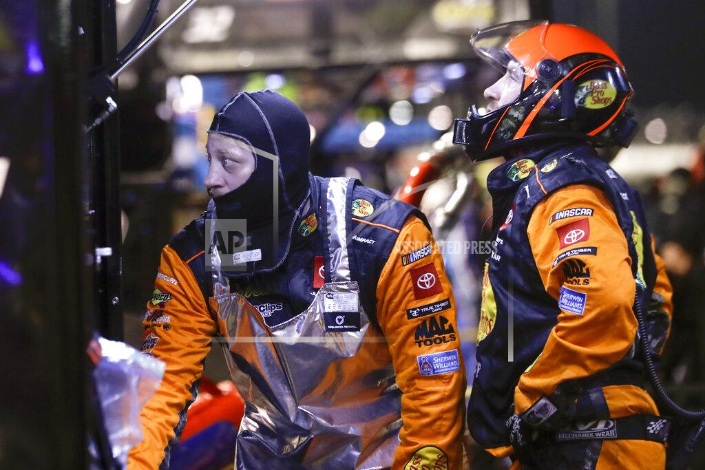 Brynn Anderson Crew members for Martin Truex Jr. watch from the pits during the NASCAR Cup Series auto race Wednesday, May 20, 2020, in Darlington, S.C. (AP Photo/Brynn Anderson)
