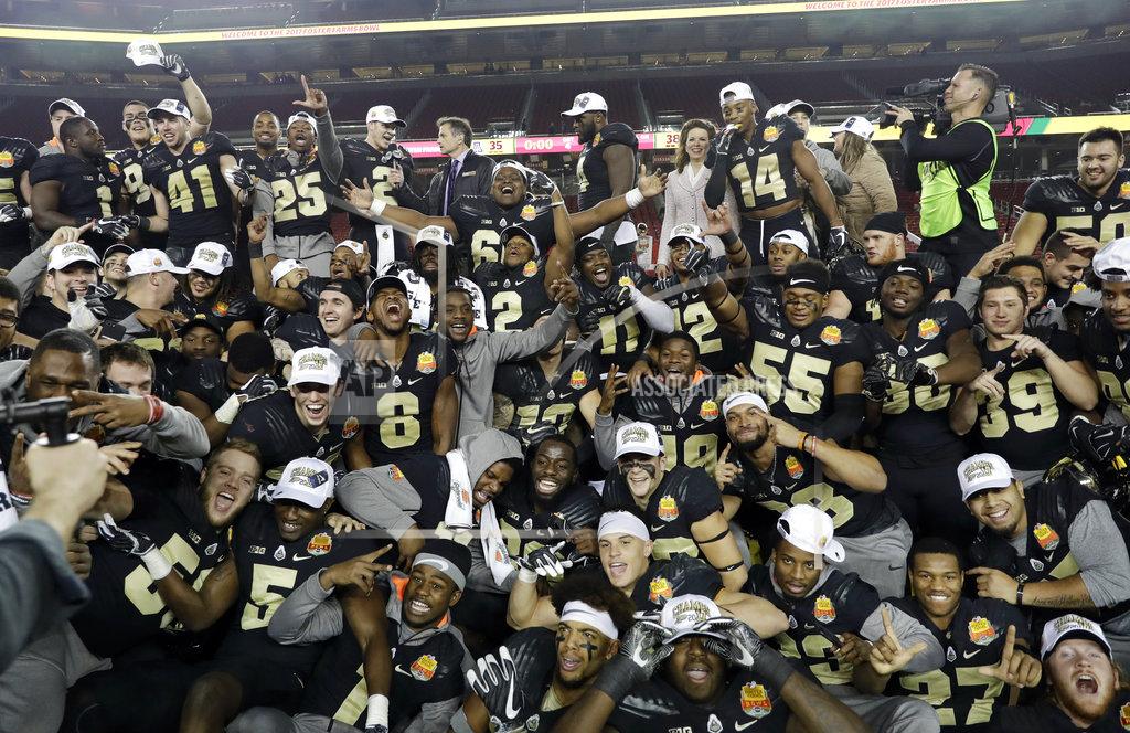 Marcio Jose Sanchez FILE - In this Dec. 27, 2017, file photo, Purdue players celebrate after a 38-35 win over Arizona during the Foster Farms Bowl NCAA college football game, in Santa Clara, Calif. The overall graduation rates for athletes on bowl-bound FBS football programs continues to climb, though the disparity in the rates between white and African-American players widened slightly, according to a study released on Monday, Dec. 3, 2018. (AP Photo/Marcio Jose Sanchez)