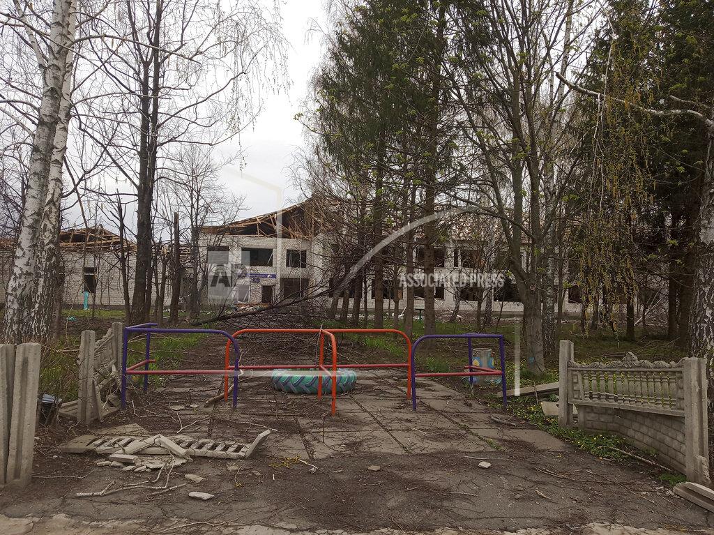 Valentina Grusha This April 26, 2022 photo provided by Ukrainian school administrator Valentina Grusha shows damage to the Cooks Comprehensive school complex in Kukhari, Ukraine. The village outside Kyiv was under Russian occupation in March and April, until Ukrainian forces drove them out. (Valentina Grusha via AP)