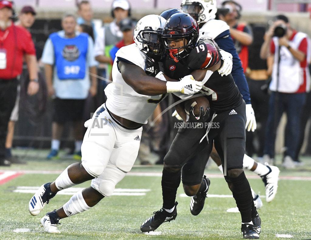Timothy D. Easley Georgia Tech linebacker Victor Alexander (9) grabs Louisville running back Hassan Hall (19) during the first half of an NCAA college football game, Friday, Oct. 5, 2018, in Louisville, Ky. (AP Photo/Timothy D. Easley)