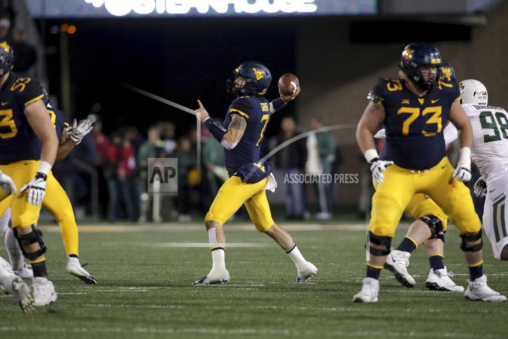 Ray Thompson West Virginia quarterback Will Grier (7) attempts a pass during the first half of an NCAA college football game against Baylor, Thursday, Oct. 25, 2018, in Morgantown, W.Va. (AP Photo/Raymond Thompson)
