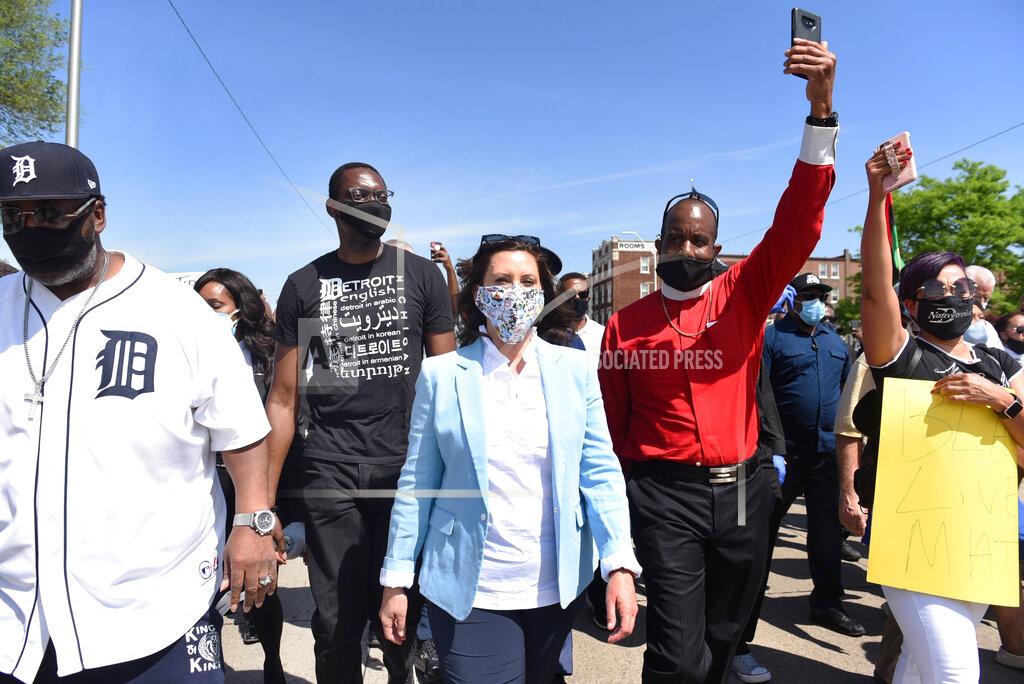 Clarence Tabb Jr. FILE - In this Thursday, June 4, 2020 file photo, Gov. Gretchen Whitmer, center, joins others during a rally in Highland Park, Mich., in honor of George Floyd, a Black man who died the previous week while being arrested by Minneapolis police. On Friday, July 17, 2020, The Associated Press reported on stories circulating online incorrectly asserting that Whitmer, the Democratic governor of Michigan, is the niece of billionaire investor and philanthropist George Soros. A look at the lineages of Whitmer and Soros shows he is not her uncle. (Clarence Tabb, Jr./Detroit News via AP)
