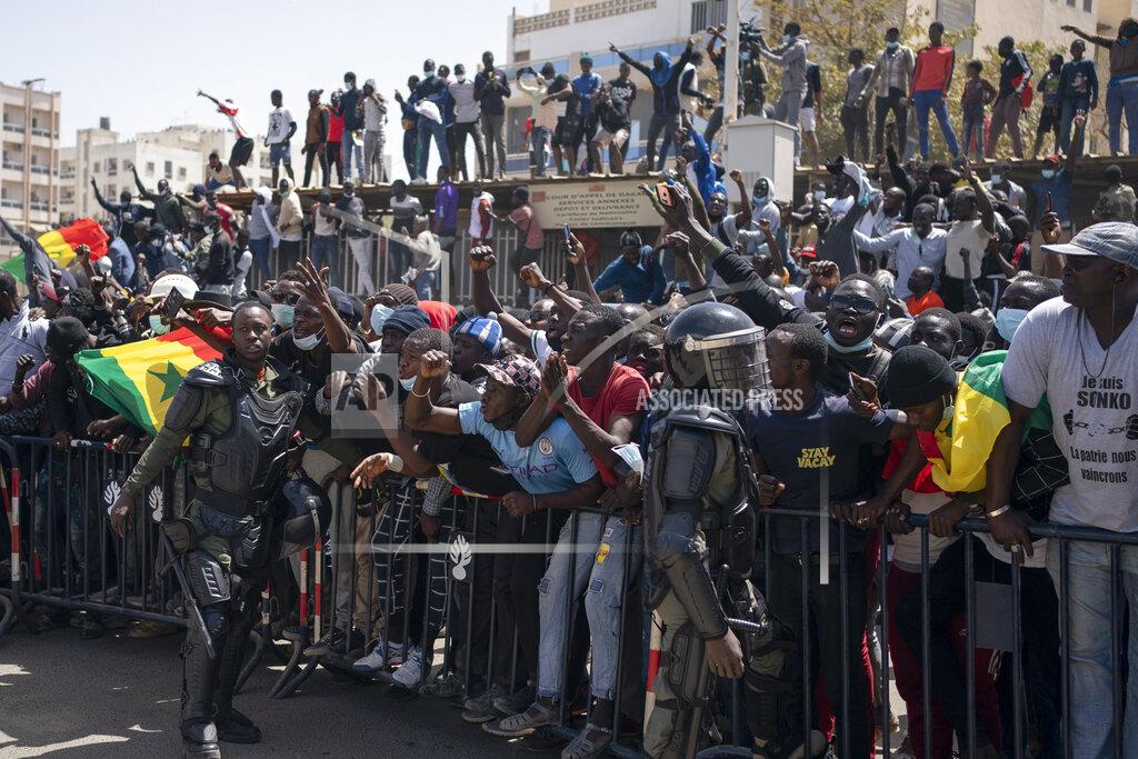 Leo Correa Demonstrators shout slogans during a protest against the arrest of opposition leader and former presidential candidate Ousmane Sonko near the Justice Palace of Dakar, Senegal, Monday, March 8, 2021. A Senegalese court cleared the way Monday for Sonko's release pending his rape trial in a case that already has sparked deadly protests and threatened to erode the country's reputation as one of West Africa's most stable democracies. (AP Photo/Leo Correa)