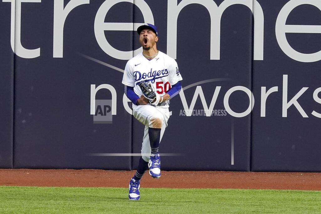 Tony Gutierrez Los Angeles Dodgers right fielder Mookie Betts celebrates after robbing Atlanta Braves' Marcell Ozuna of a home during the fifth inning in Game 6 of a baseball National League Championship Series Saturday, Oct. 17, 2020, in Arlington, Texas. (AP Photo/Tony Gutierrez)