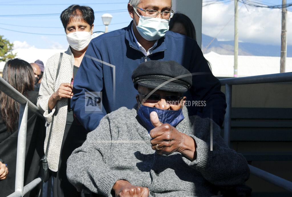 Nardus Engelbrecht Anglican Archbishop Emeritus, Desmond Tutu gestures as he arrives to receive a shot of the COVID-19 vaccine, at the Brooklyn Chest Hospital in Cape Town, South Africa, Monday, May 17, 2021. South Africa has started its mass vaccination drive with the goal of inoculating nearly 5 million citizens aged 60 and above by the end of June. (AP Photo/Nardus Engelbrecht)