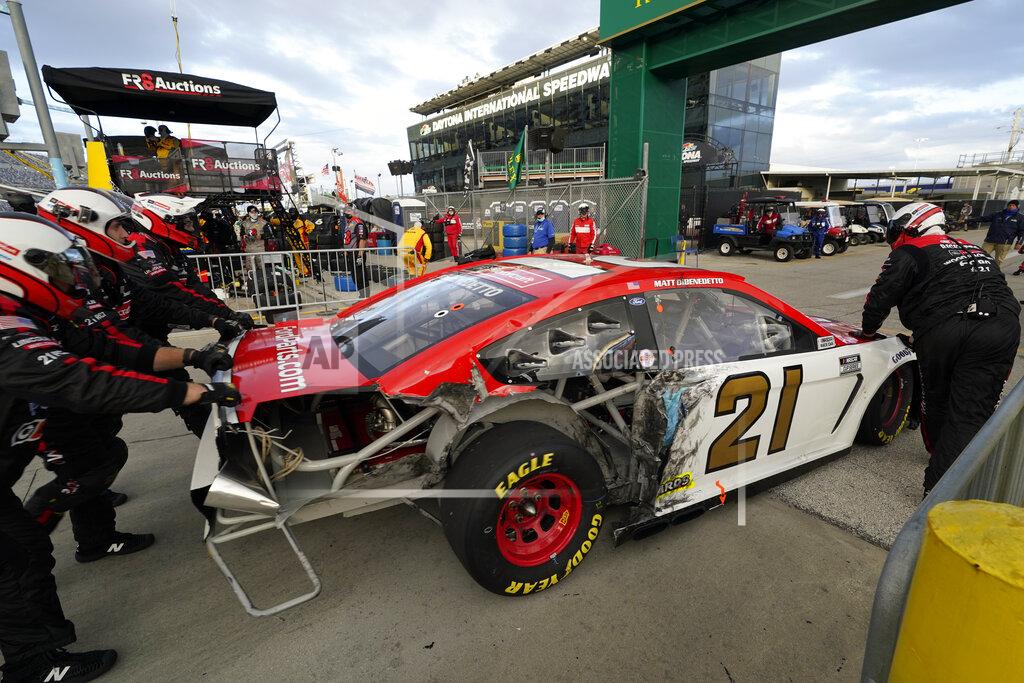 John Raoux Matt DiBenedetto crew pushes his car to the garage after he was involved in a crash in the NASCAR Cup Series road course auto race at Daytona International Speedway, Sunday, Feb. 21, 2021, in Daytona Beach, Fla. (AP Photo/John Raoux)