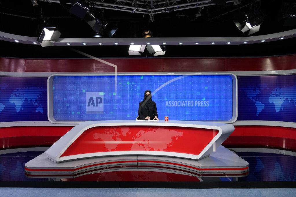 Ebrahim Noroozi TV anchor Khatereh Ahmadi wears a face covering as she reads the news on TOLO NEWS, in Kabul, Afghanistan, Sunday, May 22, 2022. Afghanistan's Taliban rulers have begun enforcing an order requiring all female TV news anchors in the country to cover their faces while on-air. The move Sunday is part of a hard-line shift drawing condemnation from rights activists. (AP Photo/Ebrahim Noroozi)