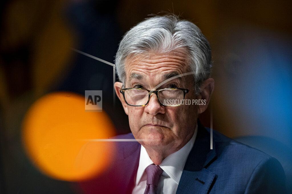FILE - In this Dec. 1, 2020 file photo, Federal Reserve Chair Jerome Powell listens during a Senate Banking Committee hearing on Capitol Hill in Washington. Powell on Thursday, April 8, 2021 said the U.S. economy, boosted by quickening vaccinations and signs of rapid hiring, is headed toward a strong recovery, though he cautioned not all will immediately benefit. (Al Drago/The New York Times via AP, Pool)