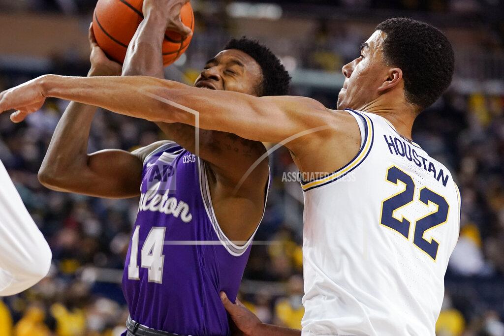 Carlos Osorio Tarleton State guard Javontae Hopkins (14) is defended by Michigan forward Caleb Houstan (22) during the first half of an NCAA college basketball game, Wednesday, Nov. 24, 2021, in Ann Arbor, Mich. (AP Photo/Carlos Osorio)