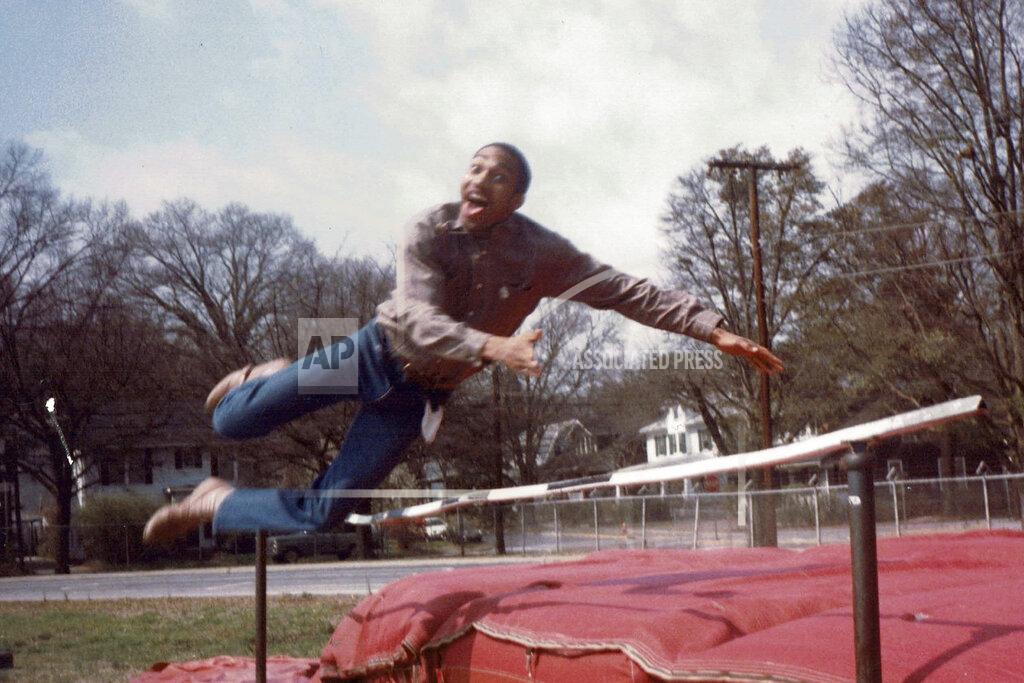 Uncredited In this late 1980's photo provided by musician DJ Nabs, his childhood friend, Alton Lucas, jumps in a field at Durham High School in Durham, N.C. As a teenager, Alton Lucas believed basketball or music would pluck him out of North Carolina and take him around the world. (Courtesy DJ Nabs via AP)