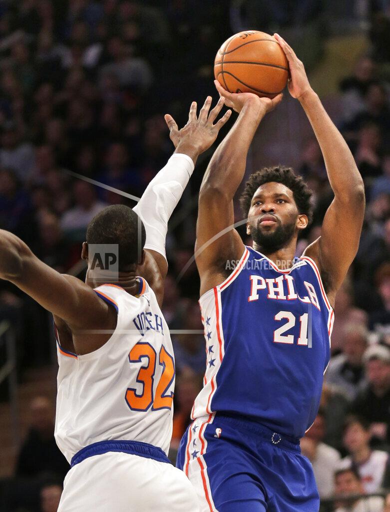 Seth Wenig Philadelphia 76ers' Joel Embiid, right, shoots over New York Knicks' Noah Vonleh during the first half of an NBA basketball game, Sunday, Jan. 13, 2019, in New York. (AP Photo/Seth Wenig)