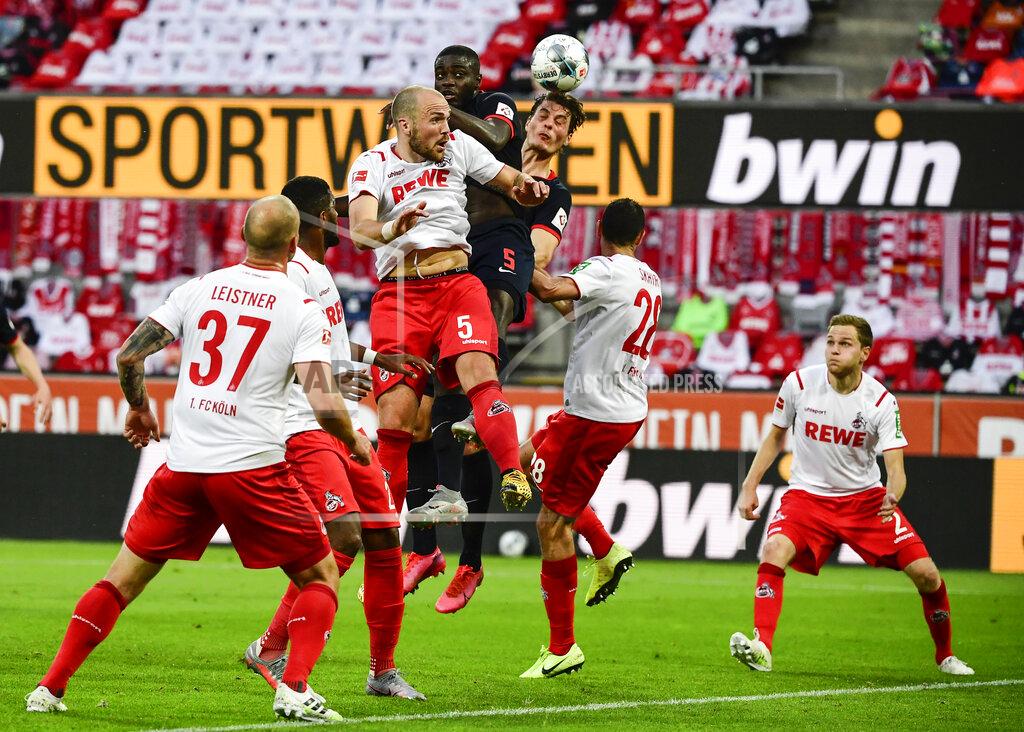 Ina Fassbender Cologne's German defender Rafael Czichos, center left, Leipzig's French defender Dayot Upamecano, center top, and Leipzig's Czech forward Patrik Schick, center right, challenge for the ball during the German Bundesliga soccer match between 1. FC Cologne and RB Leipzig, in Cologne, Germany, Monday, June 1, 2020. Because of the coronavirus outbreak all soccer matches of the German Bundesliga take place without spectators. (Ina Fassbender/Pool via AP)