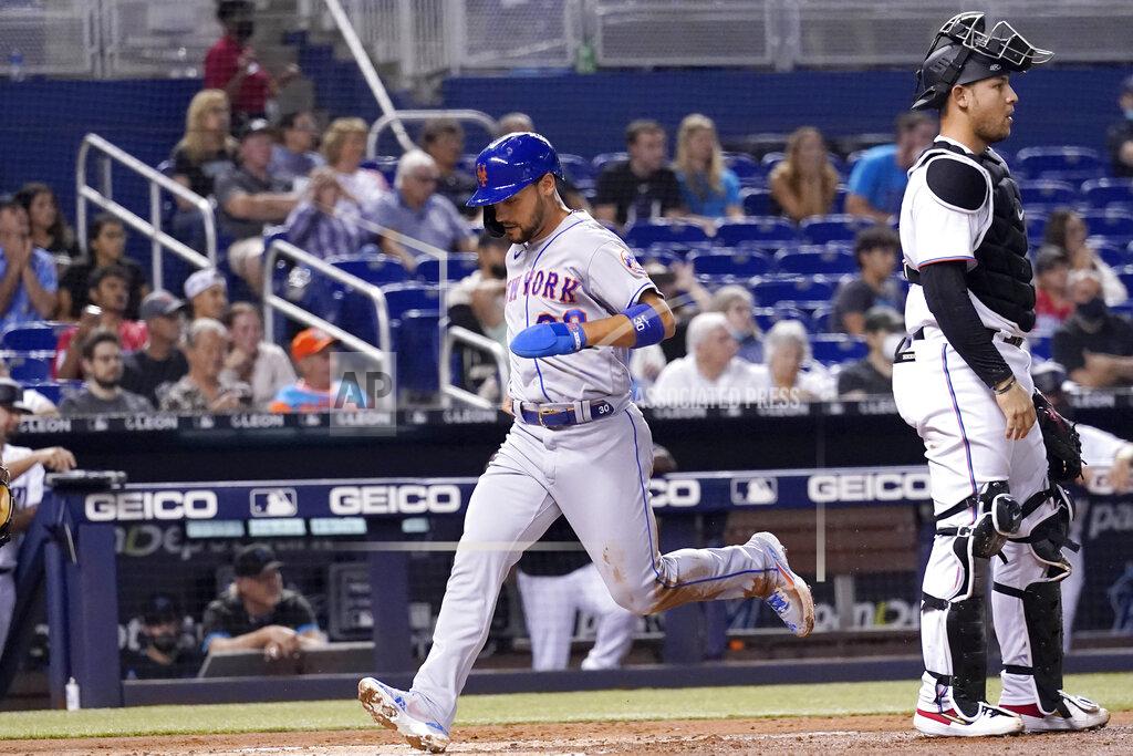 Lynne Sladky New York Mets' Michael Conforto, left, scores past Miami Marlins catcher Alex Jackson on a throwing error by Miami Marlins starting pitcher Zach Thompson during the second inning of a baseball game, Wednesday, Aug. 4, 2021, in Miami. (AP Photo/Lynne Sladky)