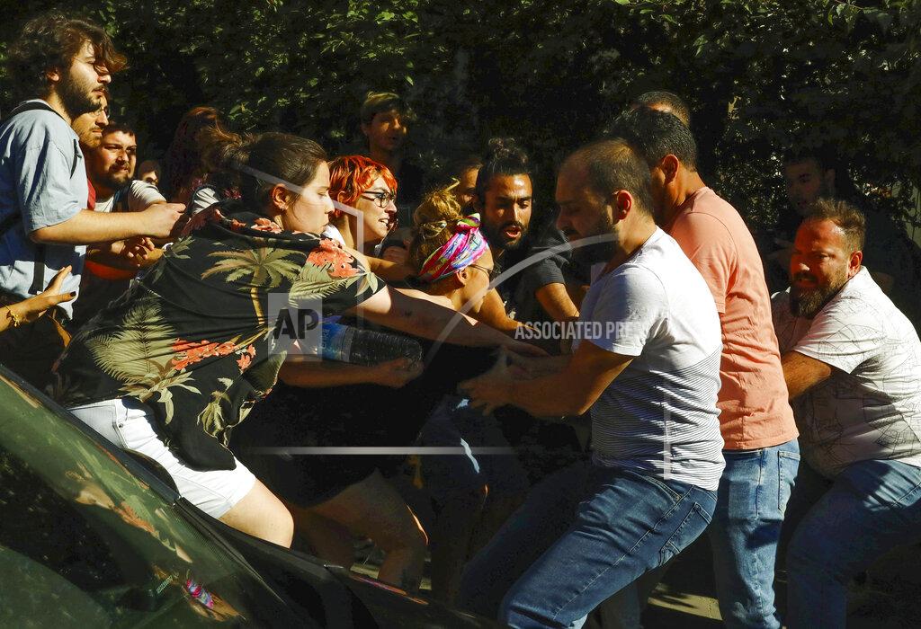 Ali Unal Turkish plain clothes policemen, right, scuffle with protesters during the LGBTQ Pride March in Ankara, Turkey, Tuesday, July 5, 2022. Police in Turkey’s capital have broken up a LGBTQ Pride march and detained dozens of people. Turkish authorities have banned LGBTQ events. (AP Photo/Ali Unal)