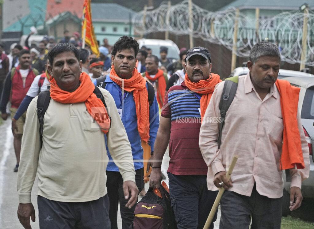 Uncredited Hindu devotees leave for the Amarnath Yatra annual pilgrimage to to an icy Himalayan cave, in Nunwun, Pahalgam, south of Srinagar, Indian-controlled Kashmir, Thursday, June 30, 2022. Officials say pilgrims face heightened threat of attacks from rebels fighting against Indian rule and have for the first time tagged devotees with wireless tracking system. They also have deployed drones for surveillance. (AP Photo)