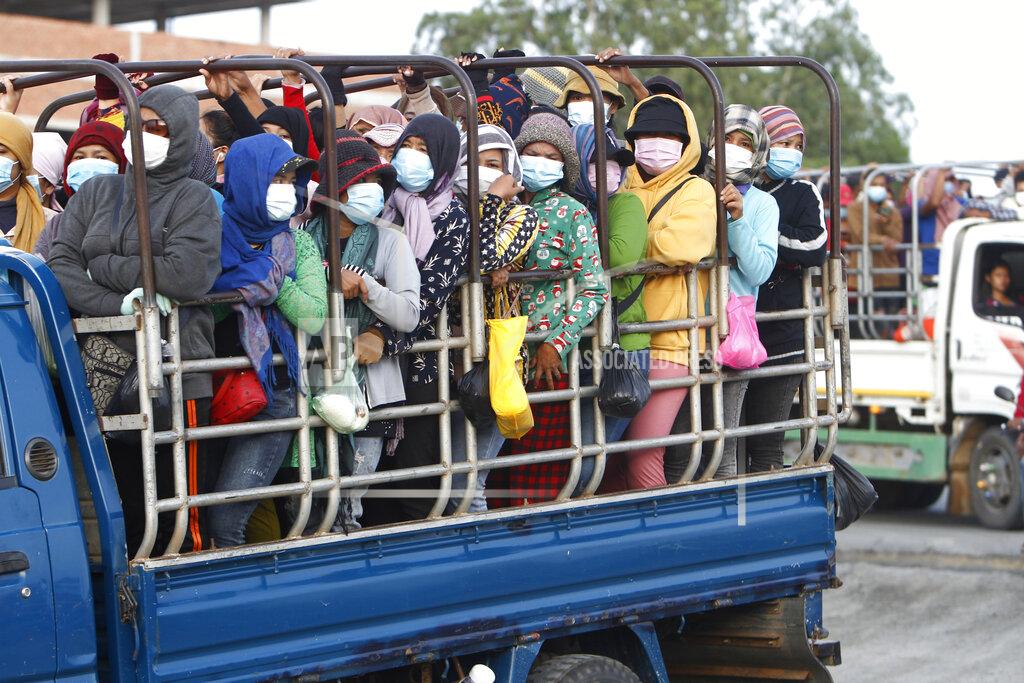 Heng Sinith Garment workers stand on the trucks as they head to work outside Phnom Penh, Cambodia, Thursday, May 6, 2021. Cambodia on Thursday ended a lockdown in the capital region. (AP Photo/Heng Sinith)