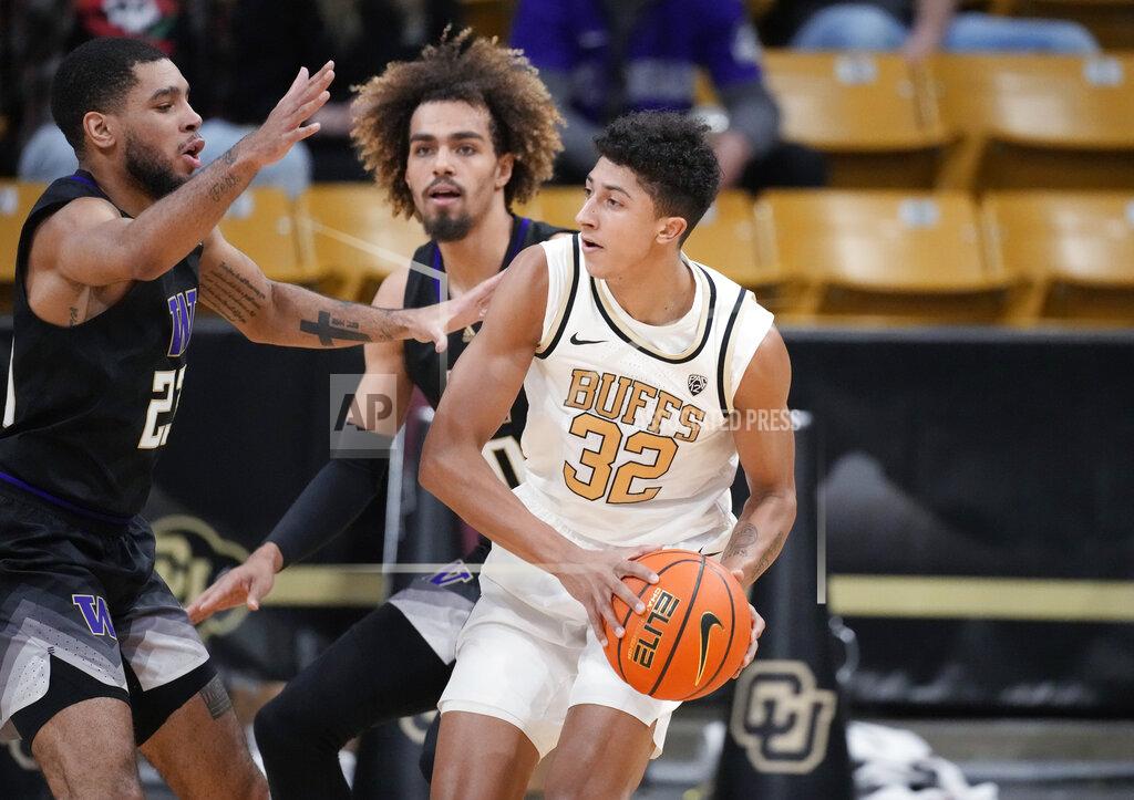 David Zalubowski Colorado guard Nique Clifford, right, looks to pass the ball as Washington guard Terrell Brown Jr., left, and forward Emmitt Matthews Jr. defend in the first first half of an NCAA college basketball game Sunday, Jan. 9, 2022, in Boulder, Colo. (AP Photo/David Zalubowski)