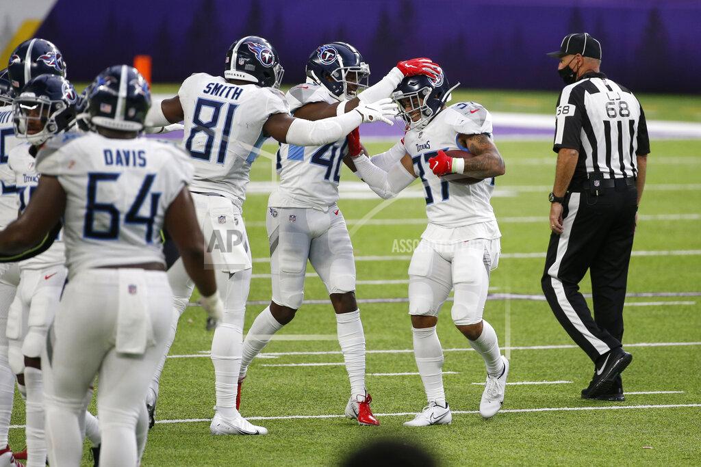 Bruce Kluckhohn Tennessee Titans safety Amani Hooker, right, celebrates with teammates after intercepting a pass during the second half of an NFL football game against the Minnesota Vikings, Sunday, Sept. 27, 2020, in Minneapolis. The Titans won 31-30. (AP Photo/Bruce Kluckhohn)