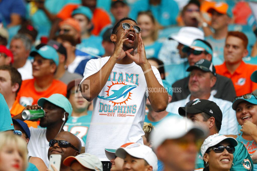 Wilfredo Lee FILE - In this Sunday, Sept. 29, 2019 file photo, a Miami Dolphins fan yells, during the first half at an NFL football game against the Los Angeles Chargers, in Miami Gardens, Fla. The Miami Dolphins NFL football team has decided to allow up to 13,000 socially distancing fans to attend their home opener against the Buffalo Bills on Sept 20, with the approval of state and local political leaders. (AP Photo/Wilfredo Lee, File)