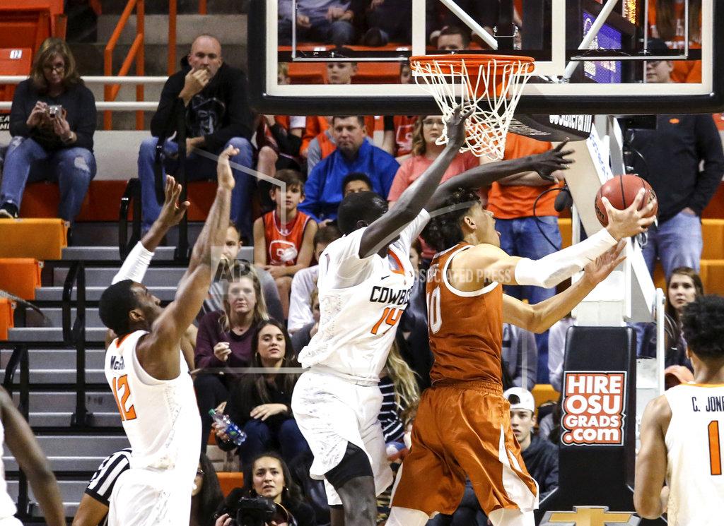 Evan Brown Texas forward Jaxson Hayes attempts a reverse layup against Oklahoma State's Yor Anei during the first half of an NCAA college basketball game Tuesday, Jan. 8, 2019, in Stillwater, Okla. (Evan Brown/Tulsa World via AP)