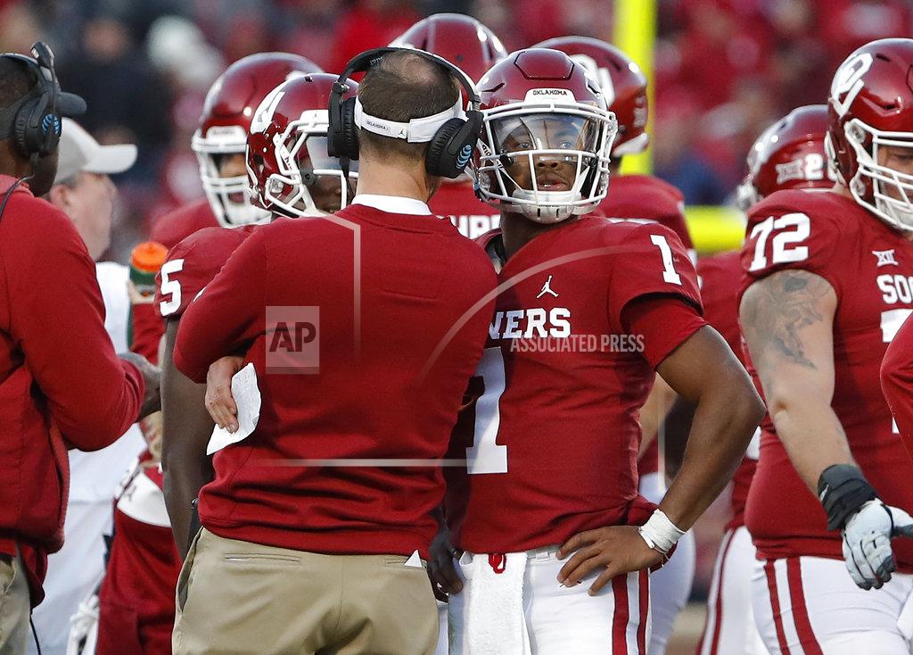 Alonzo Adams Oklahoma head coach Lincoln Riley, left, coaches Oklahoma quarterback Kyler Murray, right, during a time out against Oklahoma State in the second half of an NCAA college football game in Norman, Okla., Saturday, Nov. 10, 2018. Oklahoma won 48-47. (AP Photo/Alonzo Adams)