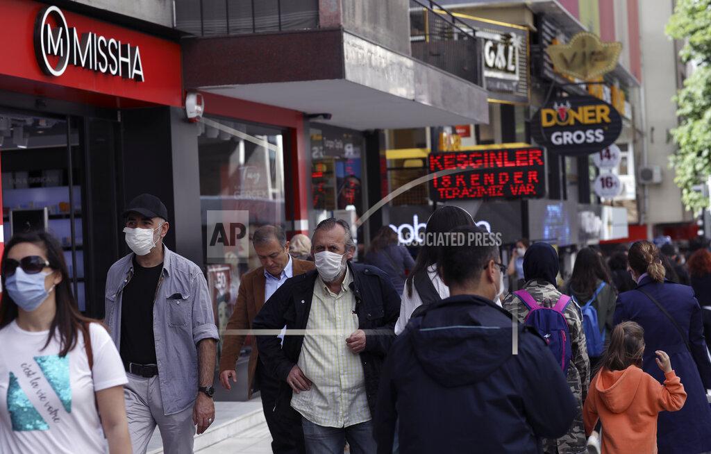 Burhan Ozbilici People walk along popular Tunali Hilmi Street, in Ankara, Turkey, Wednesday, June 3, 2020, days after the government lifted a series of restrictions imposed to fight the coronavirus pandemic. People crowded popular streets and parks while restaurants and cafes welcomed sit-in customers and beaches and museums reopened as part of Turkey's broadest easing of coronavirus restrictions. (AP Photo/Burhan Ozbilici)