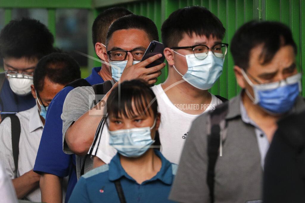 Andy Wong Commuters wearing protective face masks to help curb the spread of the new coronavirus line up to board a bus at a bus terminal in Beijing, Monday, June 22, 2020. A Beijing government spokesperson said the city has contained the momentum of a recent coronavirus outbreak that has infected a few hundreds of people, after the number of daily new cases fell to single digits. (AP Photo/Andy Wong)