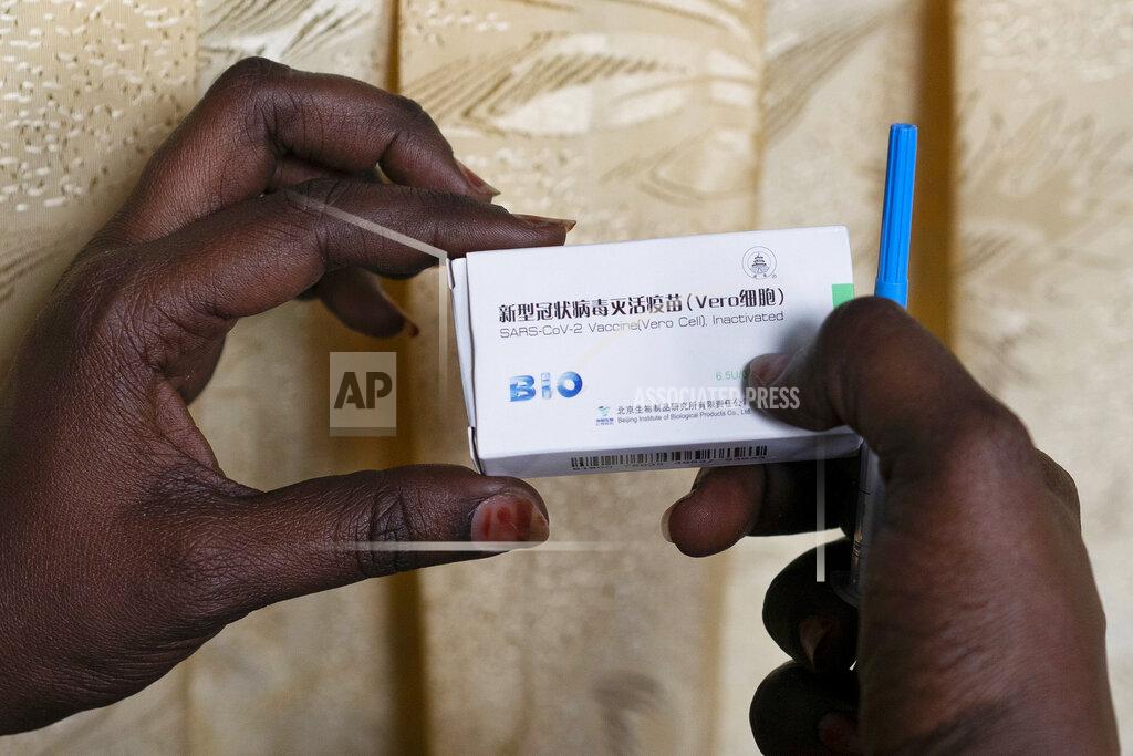 Leo Correa FILE - In this Tuesday, Feb. 23, 2021, file photo, a health worker holds a box containing a dose of China's Sinopharm vaccine during the start of the vaccination campaign against the COVID-19 at the Health Ministry in Dakar, Senegal. China’s vaccine diplomacy campaign has pledged roughly half a billion doses of its vaccines to dozens of countries. (AP Photo/Leo Correa, File)