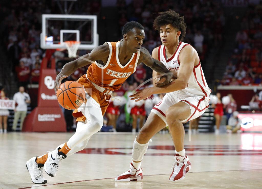 Alonzo Adams Texas guard Andrew Jones drives to the basket against Oklahoma forward Jalen Hill during the first half of an NCAA college basketball game Tuesday, Feb. 15, 2022, in Norman, Okla. (AP Photo/Alonzo Adams)