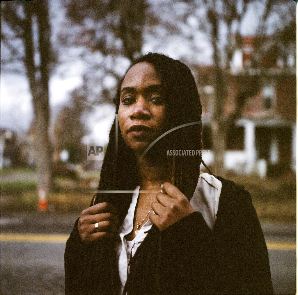 David Goldman In this photo made with a medium format film camera, Larrecsa Cox, 39, stands for a portrait in Huntington, W.Va., Thursday, March 18, 2021. Cox, a paramedic, leads the Quick Response Team that within days visits everyone who overdoses to try to pull them back from the brink. "You're not in trouble," she says, gives them the overdose reversal medication naloxone and offers help navigating their way to recovery. Huntington was once ground-zero for this epidemic. It was a hard-fought battle, but it worked. The county's overdose rate plummeted. They wrestled down an HIV crisis. Then the pandemic arrived undid much of their effort. "I can't believe we've lost all these people," said Cox. "But sometimes, you just have to focus on the living." (AP Photo/David Goldman)