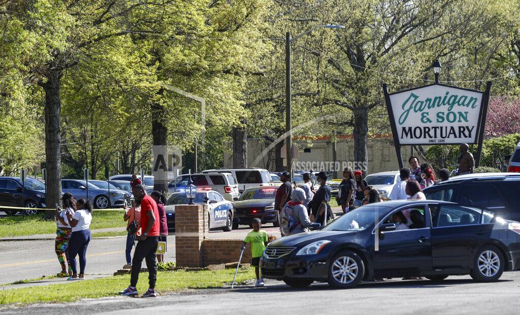 Wade Payne People gather outside Austin-East Magnet High School in Knoxville, Tenn., following a shooting at the school Monday, April 12, 2021. (AP Photo/Wade Payne)