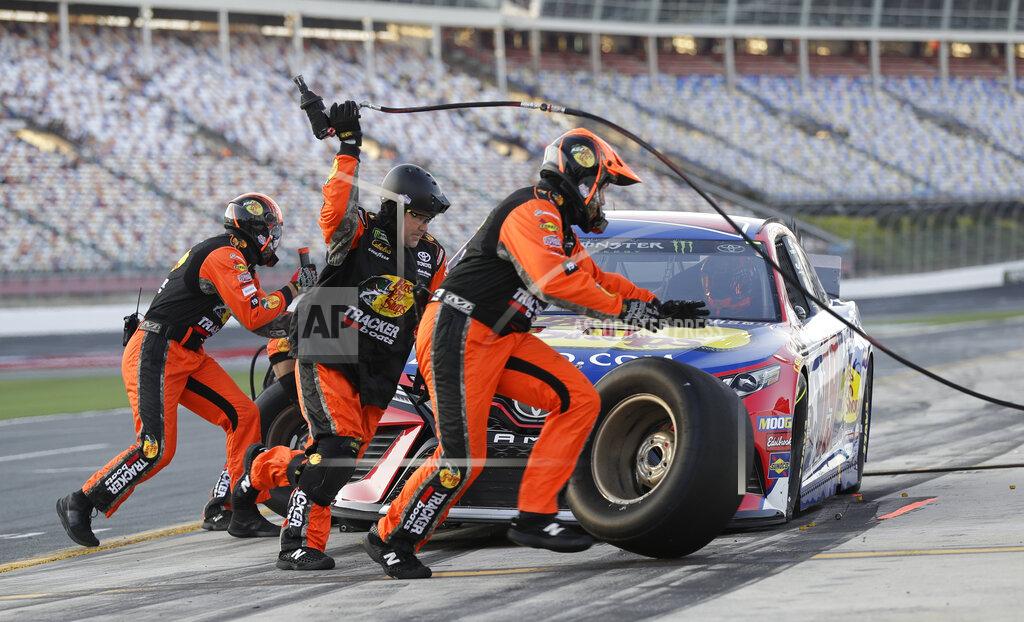 Chuck Burton Crew members perform a pit stop on driver Martin Truex Jr's car during qualifying for Saturday's NASCAR All-Star Cup series auto race at Charlotte Motor Speedway in Concord, N.C., Friday, May 17, 2019. (AP Photo/Chuck Burton)