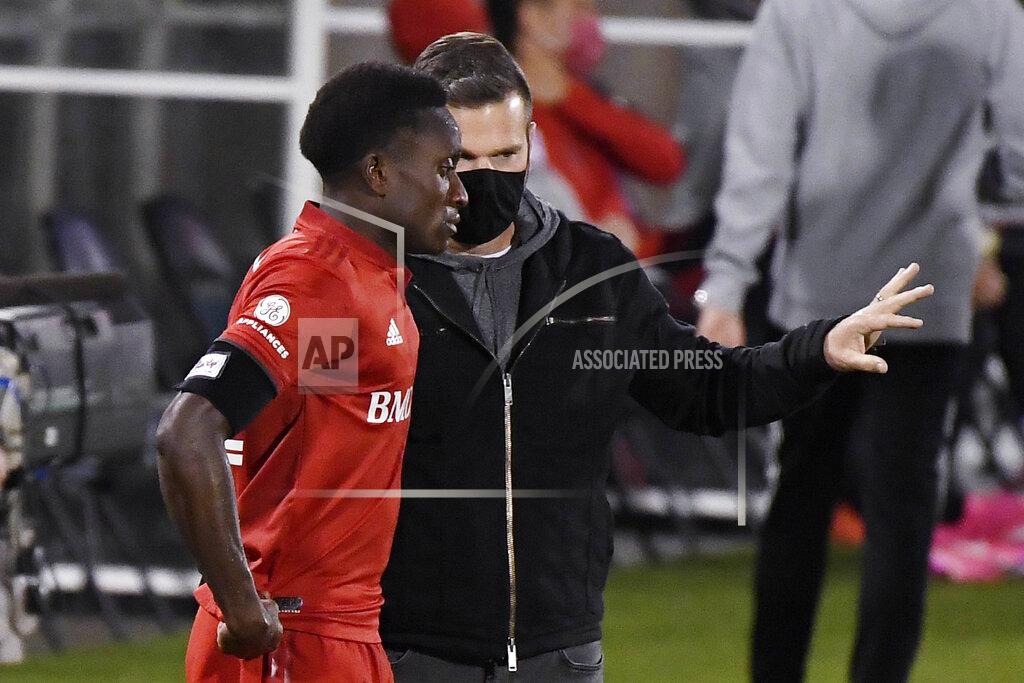 Jessica Hill Toronto FC head coach Greg Vanney, right, talks with Richie Laryea during the first half of an MLS soccer match against the New York Red Bulls, Wednesday, Oct. 14, 2020, in East Hartford, Conn. (AP Photo/Jessica Hill)