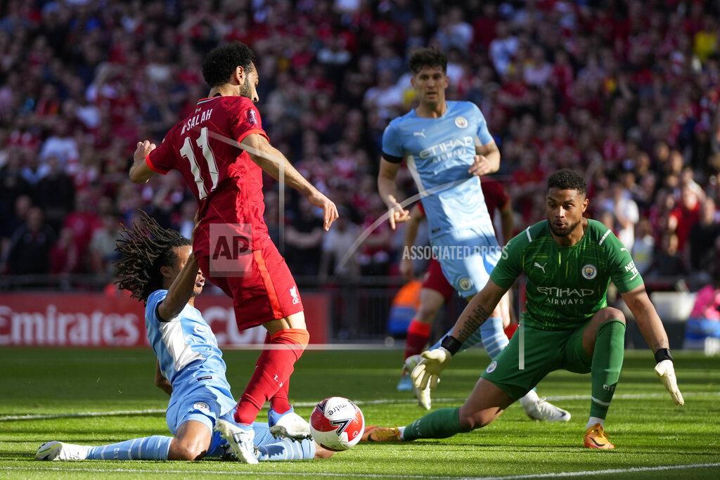 Frank Augstein Liverpool's Mohamed Salah, center, is challenged by Manchester City's Nathan Ake, left, and Manchester City's goalkeeper Zack Steffen during the English FA Cup semifinal soccer match between Manchester City and Liverpool at Wembley stadium in London, Saturday, April 16, 2022. (AP Photo/Frank Augstein)